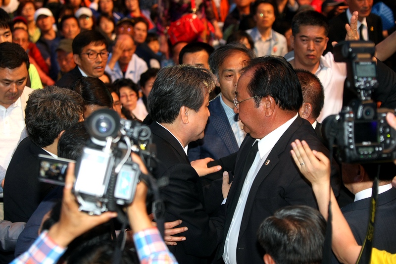김무성 새누리당 대표가 17일 오후 5·18 전야제에 참석했다가 광주시민들의 격렬한 항의를 받고 15분여 버티다가 물러나고 있다.