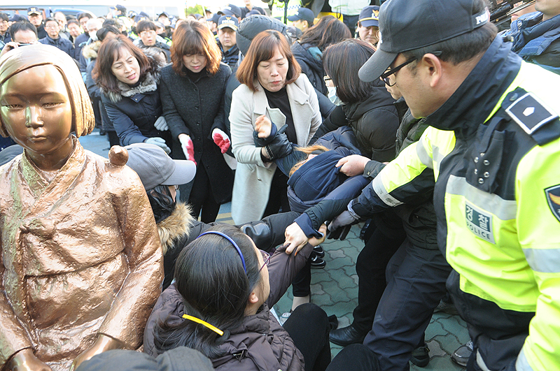 한일 ‘위안부’ 합의 1년을 맞은 28일 부산 일본영사관 앞에 처음으로 평화의 소녀상이 기습 설치됐다. 그러나 경찰과 동구청은 4시간 30분 만에 이를 강제 철거했다. 소녀상을 지키는 시민과 대학생을 경찰, 동구청 공무원들이 끌어내고 있다.