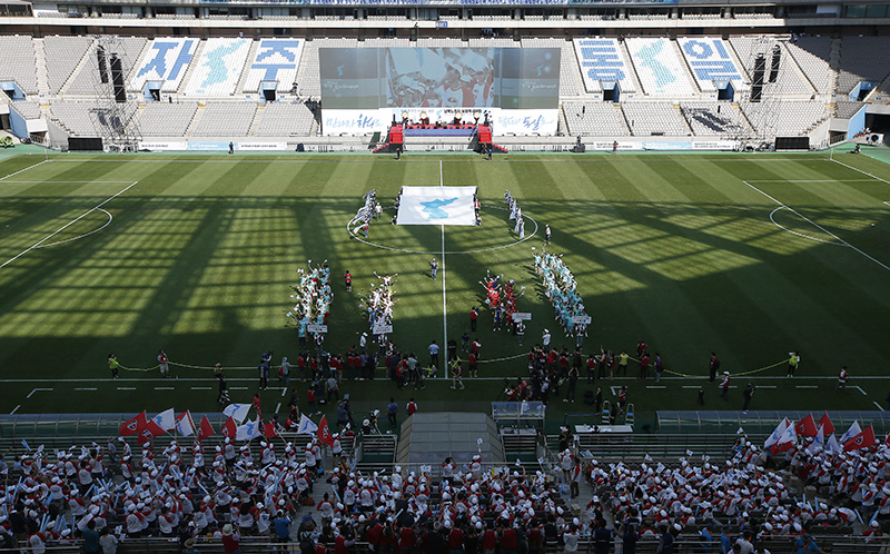 11일 오후 서울 마포구 상암월드컵경기장에서 열린 남북노동자 통일축구대회 개막식에서 한반도 단일기와 선수들이 입장하고 있다.