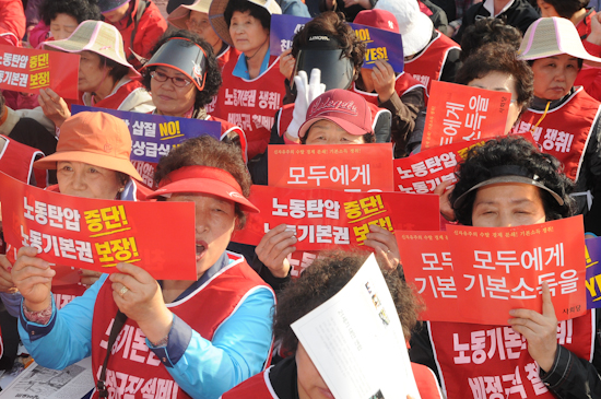 지난 2010년 열린 120주년 세계노동절 기념 범국민대회에 참석한 참가자들이 피켓을 들고 노동자의 기본소득 보장을 요구하고 있다.