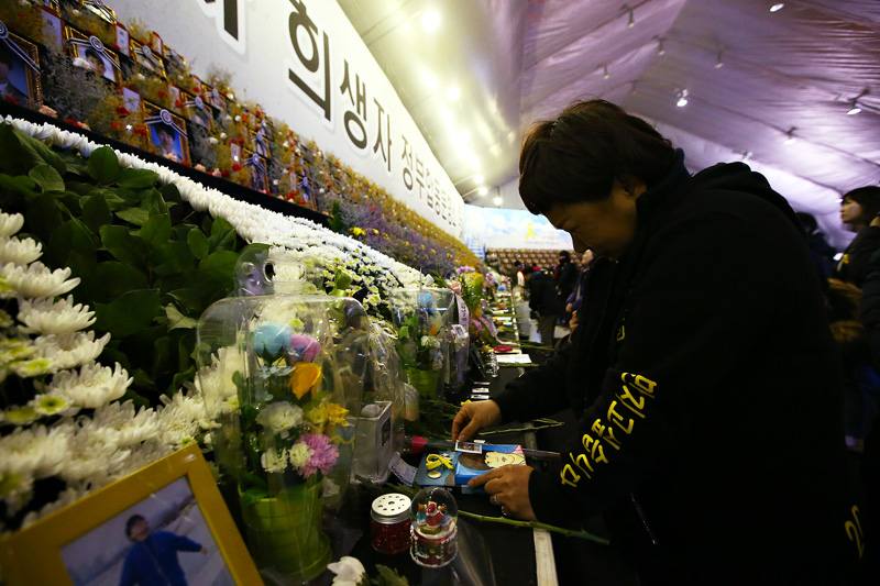 12일 오전 경기도 안산시 세월호 참사 희생자 정부합동분향소에서 열린 단원고 희생자들을 위한 추모식에서 유가족이 자녀의 영정 앞에서 눈물을 흘리고 있다. 이날 단원고에서는 생존학생 75명을 포함한 86명이 졸업했다.