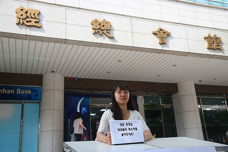 한 대학생이 21일 오전 서울 마포구 대흥동 경총회관 앞에서 1인 시위를 통해 최저임금 문제 관련 경총 회장 면담을 요구하고 있다.