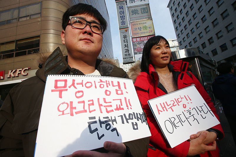 3일 오후 서울 여의도 새누리당사 앞에서 열린 새누리당 규탄 집회에서 참가자들이 새누리당 김무성 전 대표를 비판하는 피켓을 들고 있다.
