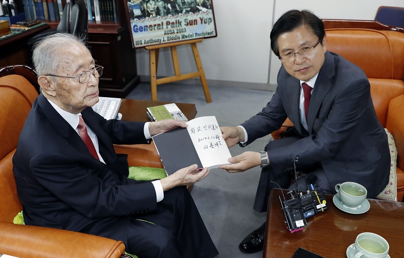 황교안 자유한국당 대표가 10일 서울 용산구 전쟁기념관 군사 편찬연구 자문위원장실에서 백선엽 예비역 대장을 예방, '백선엽의 6.25 징비록' 책을 선물 받고 있다.