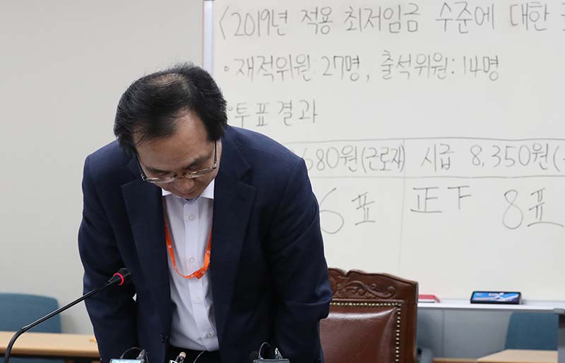 류장수 최저임금위원장이 14일 새벽 정부세종청사에서 2019년 최저임금 의결 브리핑 시작전 인사를 하고 있다. 이날 열린 회의에서 2019년 최저임금은 8350원으로 의결됐다.