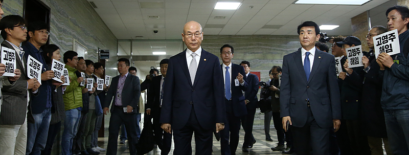 이효성 방송통신위원장이 13릴 오전 국회에서 열린 과학기술정보방송통신위원회의 방송통신위원회에 대한 국정감사장 앞에서 고영주 이사장의 사퇴를 촉구하며 피켓시위를 하고 있는 MBC노조원들 앞으로 지나고 있다.