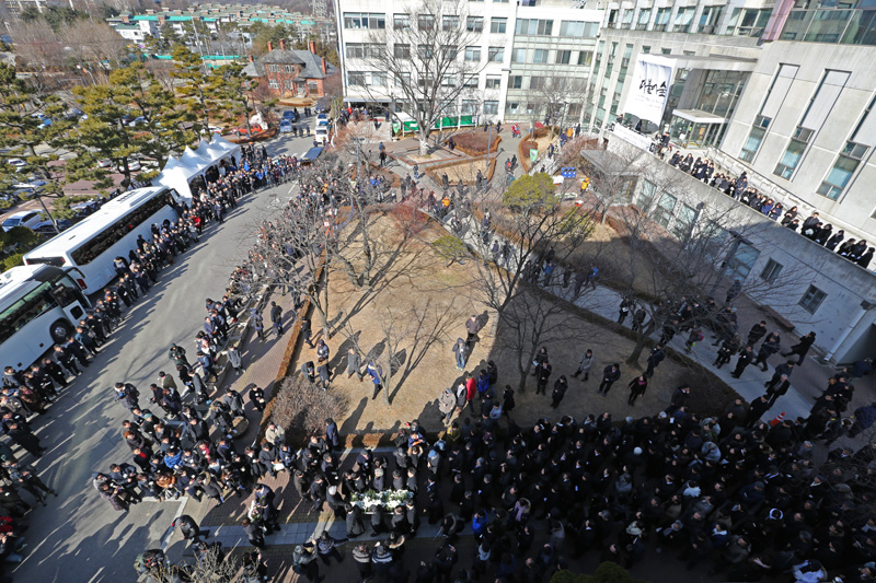 18일 서울 항동 성공회대학교에서 엄수된 고(故) 신영복 성공회대 석좌교수의 영결식을 마치고 고인의 영정과 유해가 운구 중 조문객들이 고인에게 헌화를 하고 있다.