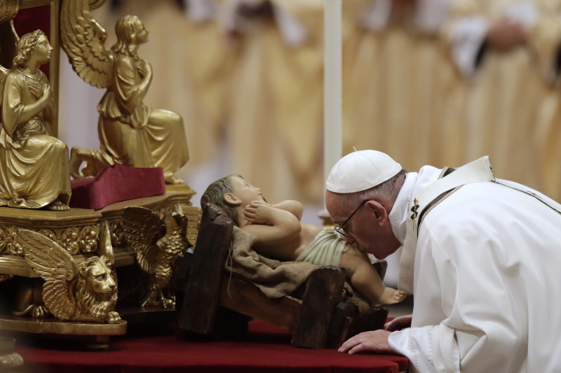 프란치스코 교황이 바티칸 성베드로 대성당에서 열린 성탄 전야 미사에서 아기 예수상에 입을 맞추고 있다.