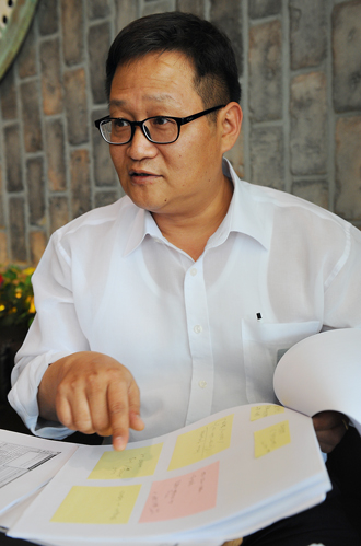 오충렬 전 실장이 투표 시스템 관련해 접수된 민원이 적혀 있는 포스트잇 용지를 보여주고 있다.