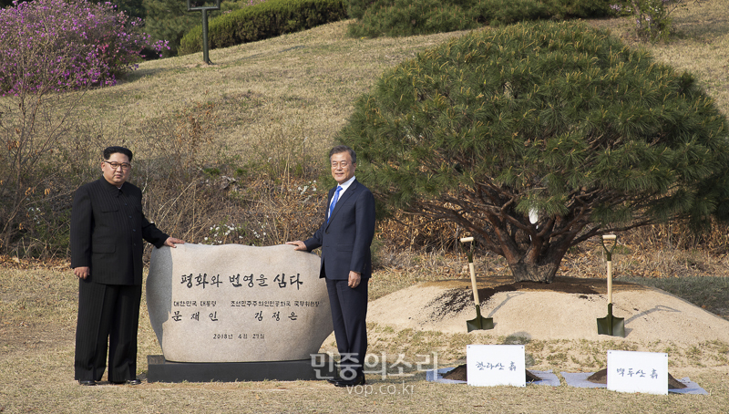 문재인 대통령과 김정은 북한 국무위위원장이 지난해 4월 27일 오후 경기도 파주 판문점 내에 남북의 화합을 상징하는 소나무를 심은 뒤 표지석 앞에서 기념촬영을 하고 있다.