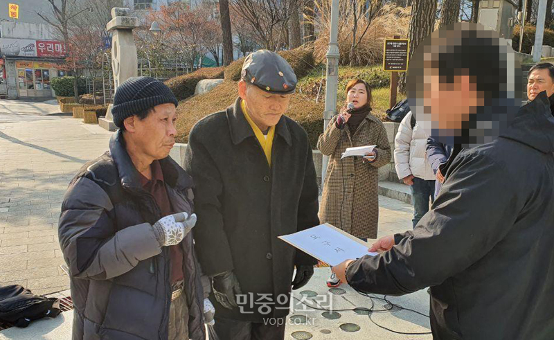 14일 중구청 앞에서 열린 기자회견에서 고 김정원 씨의 20년 지기 지인 이태헌 씨는 중구청 담당자에게 서울-경기지역으로 공영장례 적용지역을 제한하는 행정방침을 폐지해 달라는 요구서한을 전달하고 있는 모습.