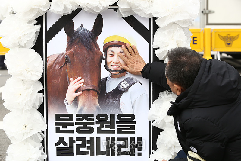 지난 6일 오전 故 문중원 기수 시민대책위와 유족들이 고인의 사망 진상규명 및 책임자 처벌을 촉구하며 서울 종로구 정부서울청사 앞 시민분향소를 출발해 청와대 앞까지 행진 이후 고 문 기수의 아버지 문군옥 씨가 아들의 사진을 어루만지고 있다. 2020.01.06